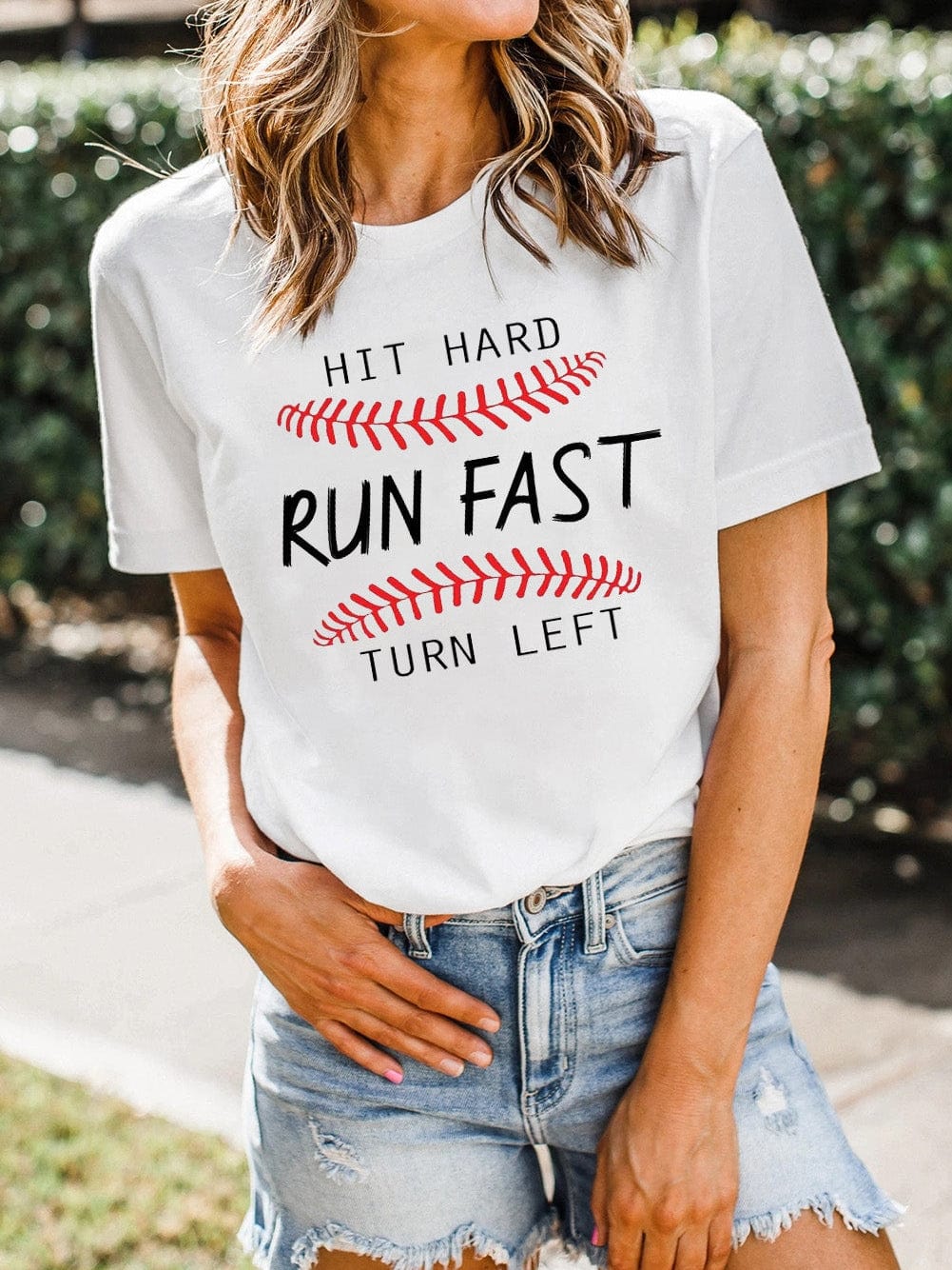 Baseball Print White Tee with "Hit Hard Run Fast Turn Left" Design