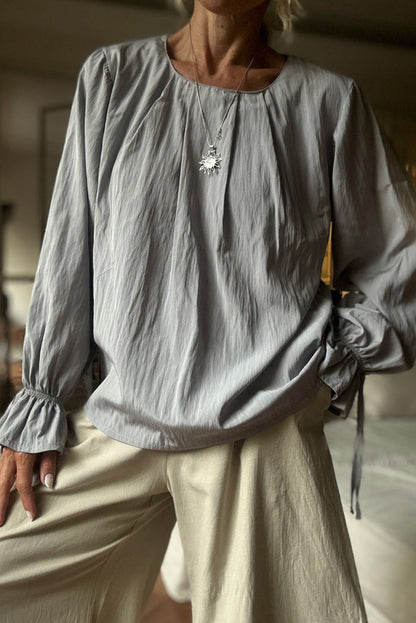 High-rise Pleated Round Neck Flounce Long Sleeve Blouse