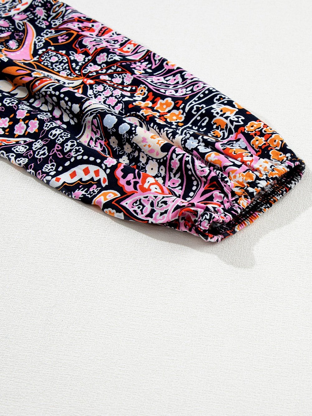 Graceful Black Floral Peplum Sweater with Ruffled Hem