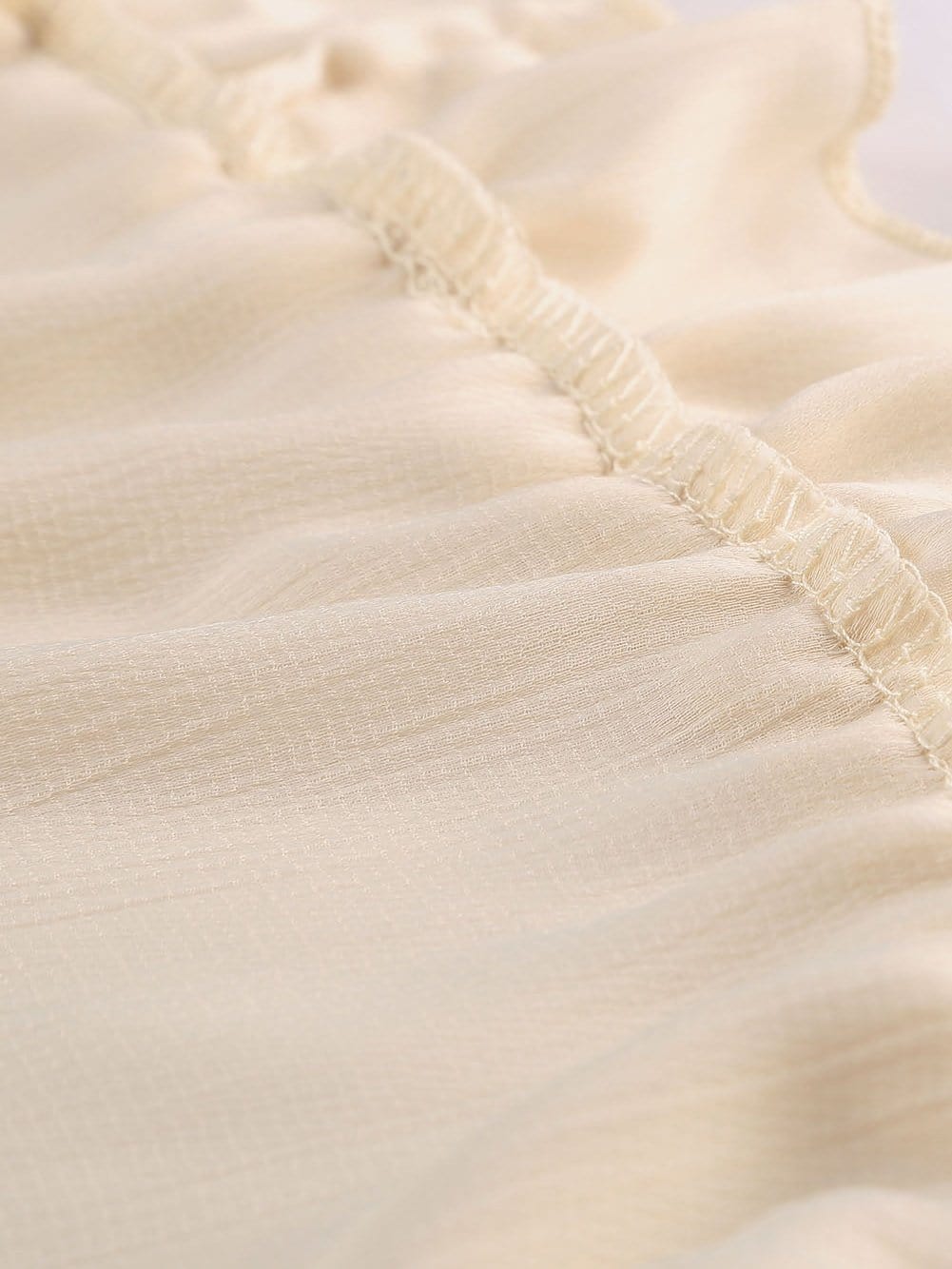 Elegant Beige Sheath Dress with V Neck Ruffle Detail and Open Back