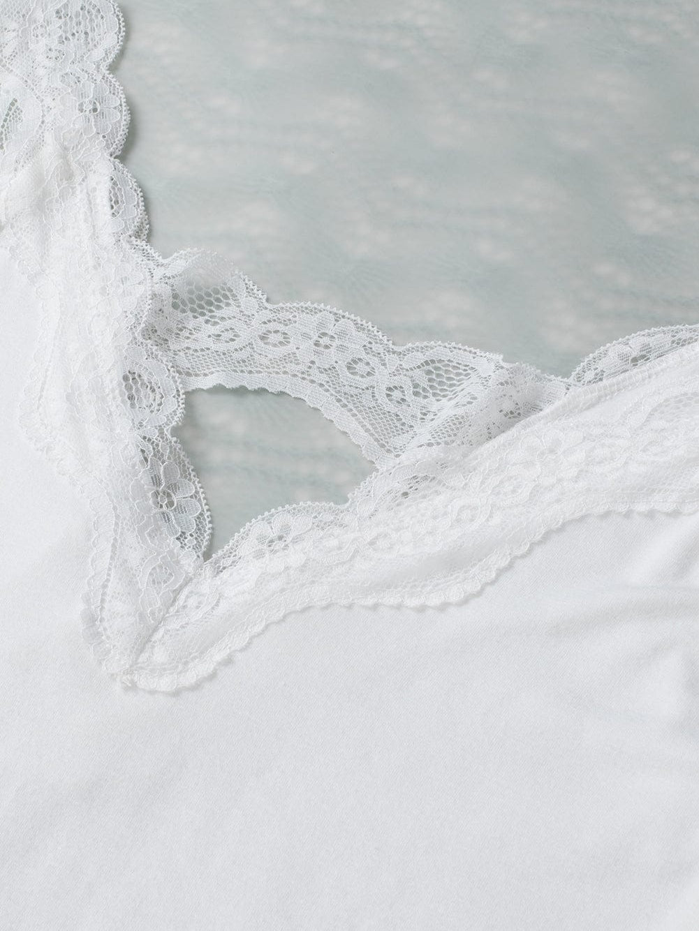 Elegant White Lace-Trimmed Flare Sleeveless Top