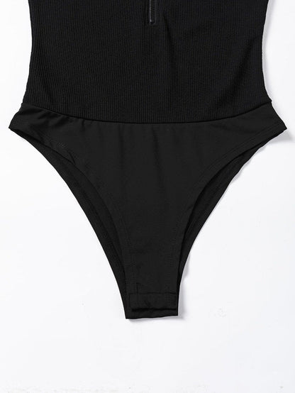 Sleek Black Ribbed Sleeveless Bodysuit with Mock Neck Zip-Up Style