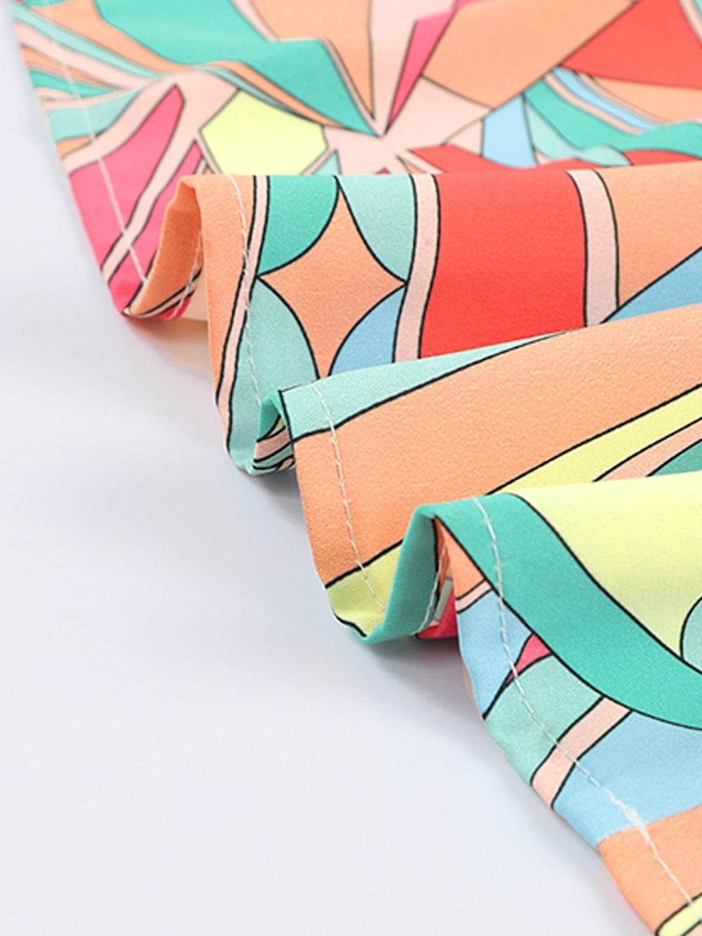 Vibrant Geometric Pattern Flared Dress with Tassel Detail